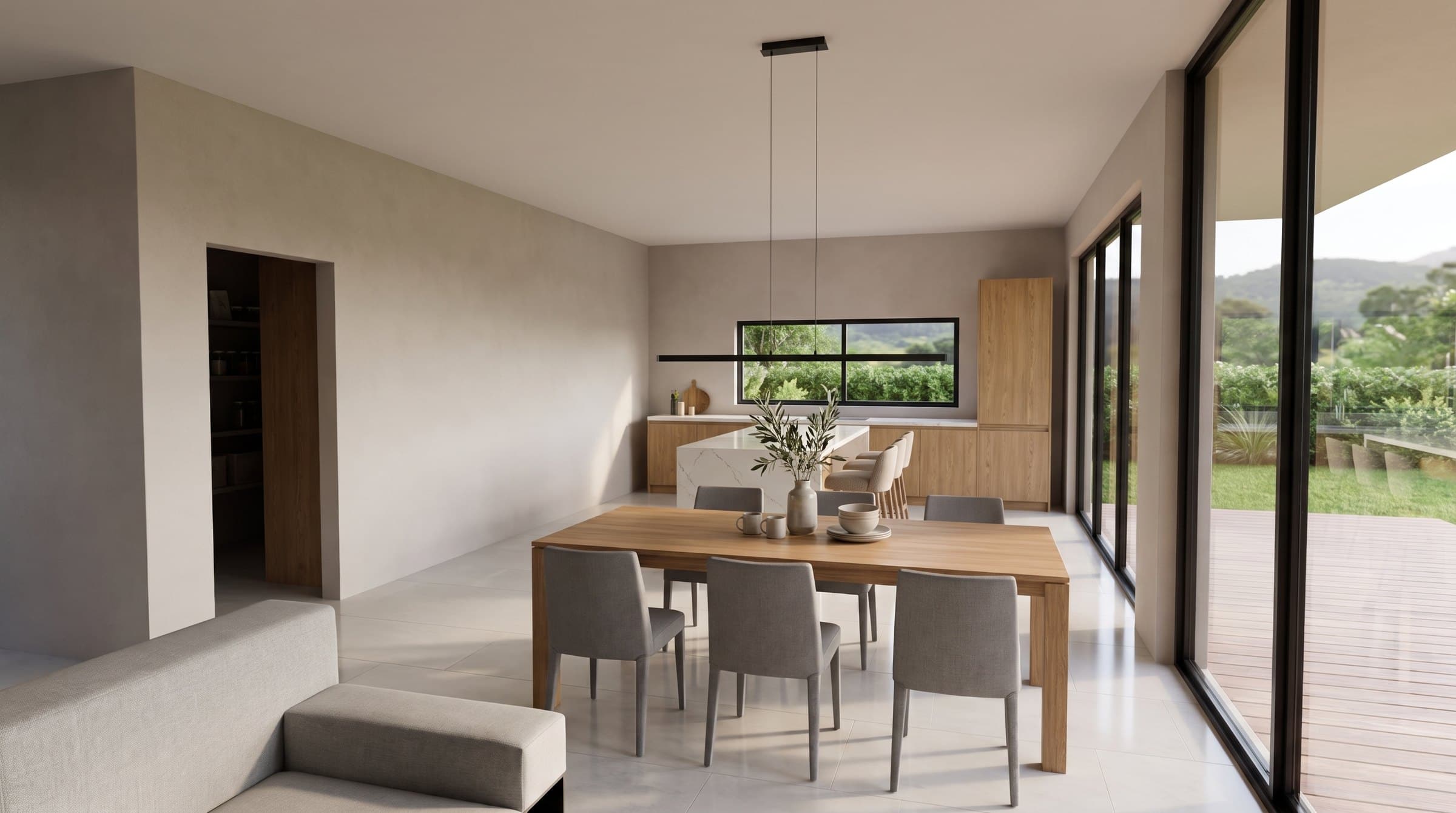 Cocina abierta con isla de cuarzo claro y muebles de roble.